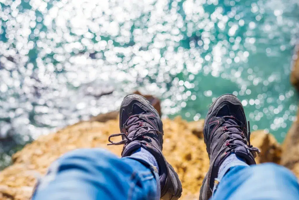 Benefits of group travel | Above view of a man legs over the sea
