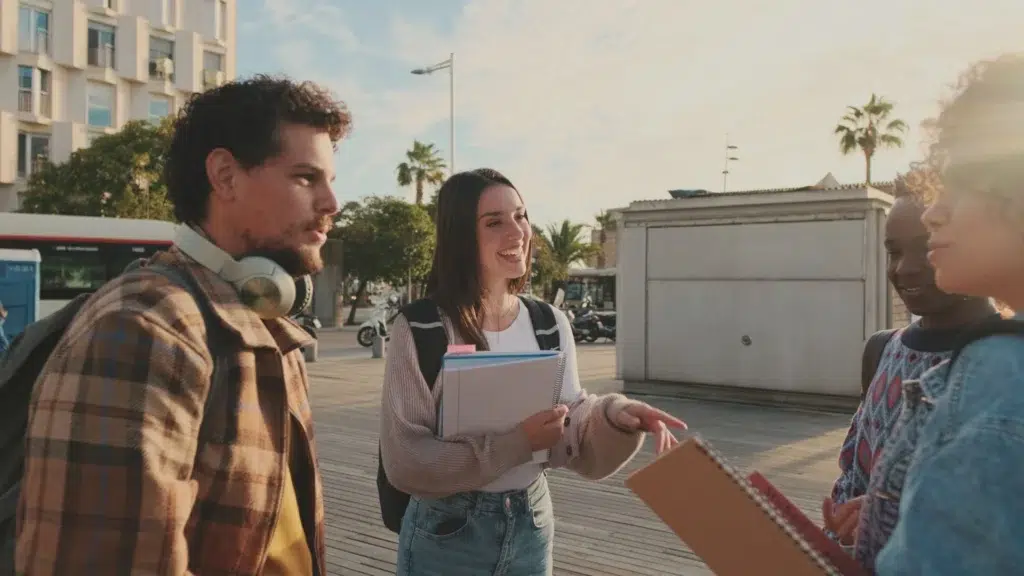 Classmates students walk down the street talking