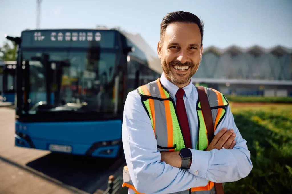 Happy driver at buss station looking at camera