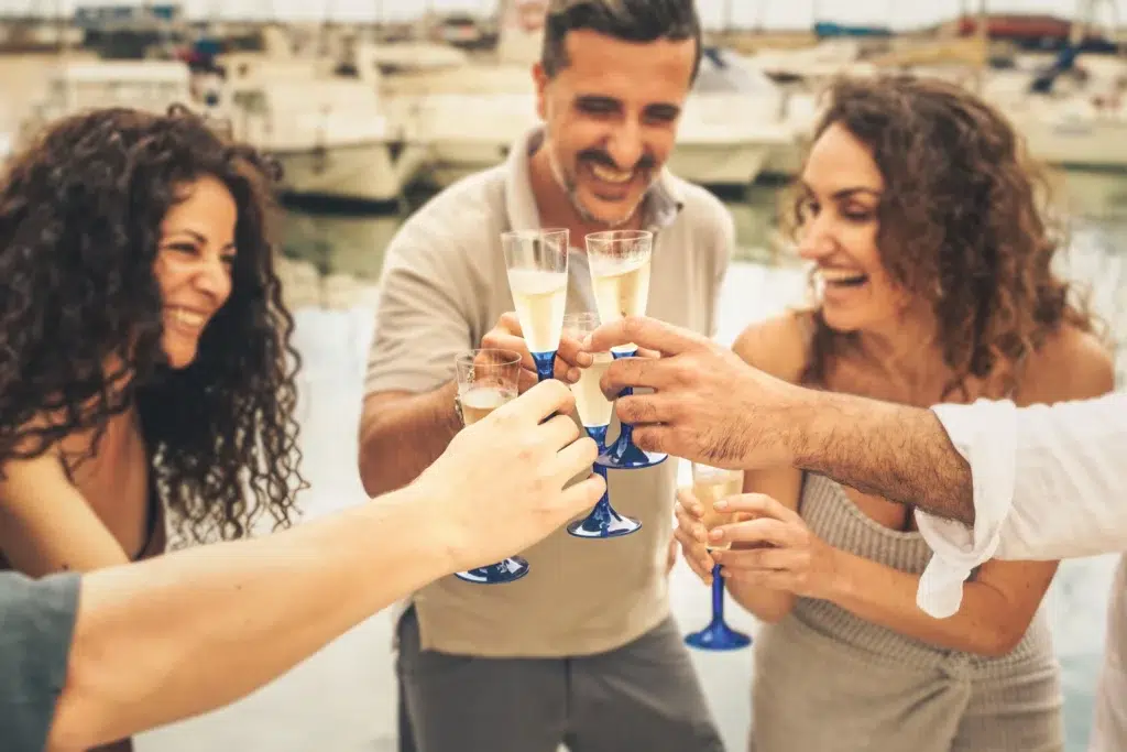 Benefits of group travel | Joyful friends toasting with champagne