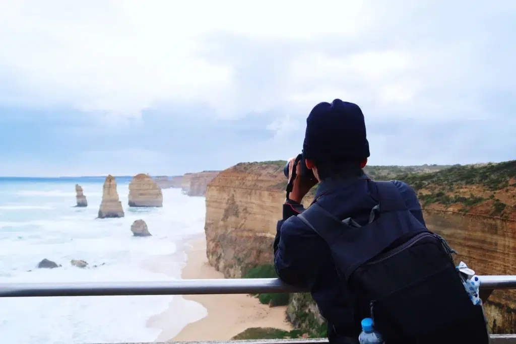Man taking photo of 12 apostles great ocean road