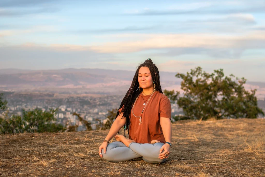 Life-changing travel experiences | Young woman is sitting in the lotus position